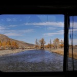 Driving across river in minivan, China